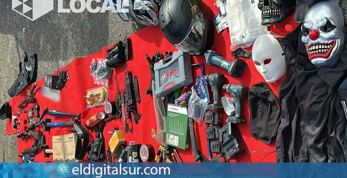 Material peligroso y equipo táctico encontrado en el vehículo de J.M.C.G., detenido en Santa Cruz. Entre los objetos hallados se incluyen un rifle de calibre 22, una carabina, una pistola de aire comprimido, machete, hacha, espráis de pimienta, herramientas como tenazas y destornilladores, y material táctico policial, máscaras y linternas.